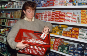 woman stocking her stores shelves with tylenol